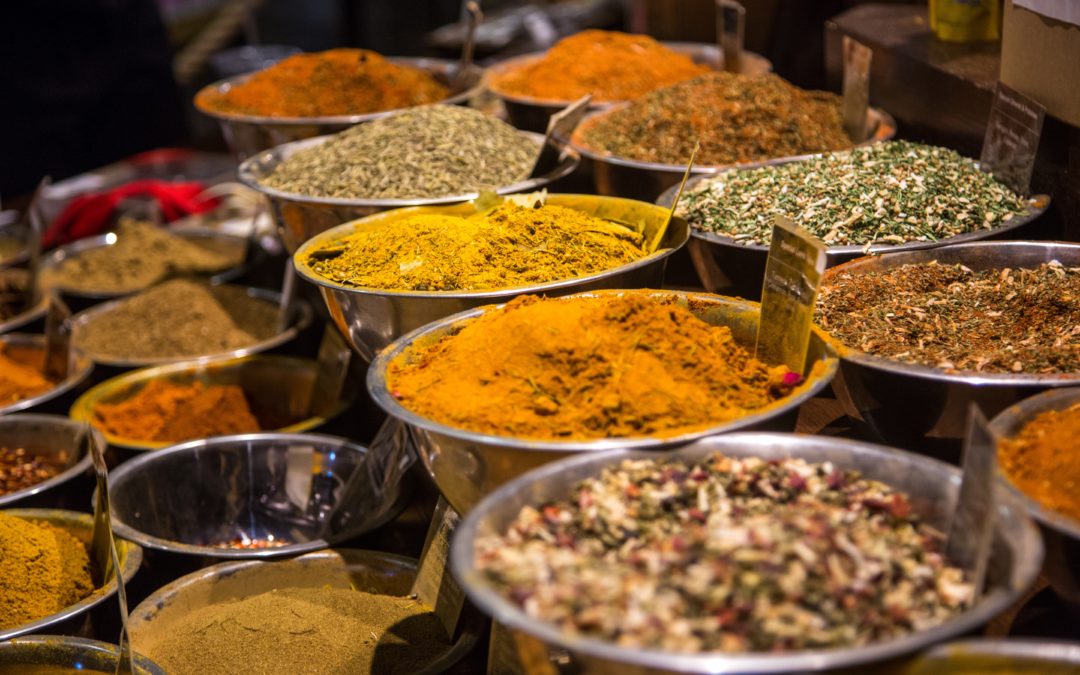 An array of spices in steel bowls